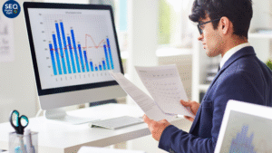 Entrepreneur examining website analytics dashboard displaying improved search engine rankings and organic growth